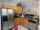 Kitchen with stainless steel appliances and wood cabinets at 922 Sandy Ridge Drive Dr, Davenport, FL 33896
