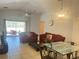Living area with red couches, a glass-top coffee table and a ceiling fan at 922 Sandy Ridge Drive Dr, Davenport, FL 33896