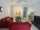 Bright living room with comfy red sectional sofa, dining table and kitchen view at 922 Sandy Ridge Drive Dr, Davenport, FL 33896