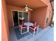 Covered patio with table and chairs, perfect for outdoor dining at 922 Sandy Ridge Drive Dr, Davenport, FL 33896