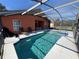 Refreshing screened pool and spa with patio furniture at 922 Sandy Ridge Drive Dr, Davenport, FL 33896