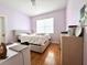 Light-filled bedroom with wood floors and window blinds at 10786 Savannah Wood Dr, Orlando, FL 32832