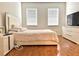 Bright bedroom with wood floors and large windows at 10786 Savannah Wood Dr # 126, Orlando, FL 32832
