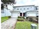 Front view of two-story townhome with double garage at 10786 Savannah Wood Dr, Orlando, FL 32832