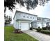 Two-story townhome with attached garage and landscaped lawn at 10786 Savannah Wood Dr # 126, Orlando, FL 32832