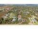 Aerial view of a home situated in a residential neighborhood with a lake in the background at 2828 Sequoyah Dr, Haines City, FL 33844