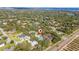Aerial view showing a house's location in a neighborhood near a lake and citrus groves at 2828 Sequoyah Dr, Haines City, FL 33844