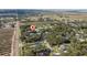 Aerial view showing home location in a quiet, secluded neighborhood with mature trees and lush landscaping at 2828 Sequoyah Dr, Haines City, FL 33844