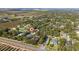 Aerial view of a home located in a residential neighborhood near citrus groves and a lake at 2828 Sequoyah Dr, Haines City, FL 33844
