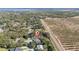 Aerial view of a home with a large backyard and a lake in the distance at 2828 Sequoyah Dr, Haines City, FL 33844