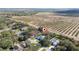 Aerial view of a single Gathering home in a residential neighborhood near citrus groves at 2828 Sequoyah Dr, Haines City, FL 33844