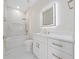 Modern bathroom with white cabinets, marble tile, and gold fixtures at 2828 Sequoyah Dr, Haines City, FL 33844