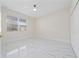 Spacious bedroom featuring a large window and marble-look tile floors at 2828 Sequoyah Dr, Haines City, FL 33844