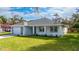 Single-story house with gray roof and white walls, landscaped yard at 2828 Sequoyah Dr, Haines City, FL 33844