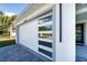 White garage door with gray trim and multiple windows at 2828 Sequoyah Dr, Haines City, FL 33844
