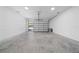 Attached garage with whitewashed brick walls and concrete flooring at 2828 Sequoyah Dr, Haines City, FL 33844
