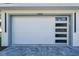 Modern white garage door featuring gray trim and multiple windows at 2828 Sequoyah Dr, Haines City, FL 33844