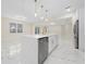 Modern kitchen with white cabinets, stainless steel appliances, and a large island at 2828 Sequoyah Dr, Haines City, FL 33844