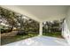Covered patio overlooking a private backyard with lush trees at 2828 Sequoyah Dr, Haines City, FL 33844