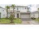 Two-story home with attached garage and landscaping at 3850 Oakville Ave, Kissimmee, FL 34741