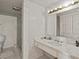 Retro bathroom with marble vanity and tiled walls at 406 Masterpiece Rd, Lake Wales, FL 33898