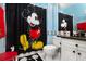 Mickey Mouse themed bathroom with black countertop and shower at 453 Water St, Kissimmee, FL 34747