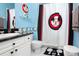 Charming bathroom with Mickey Mouse shower curtain and granite countertop at 453 Water St, Kissimmee, FL 34747