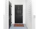 Exterior entryway with black door and welcome mat at 453 Water St, Kissimmee, FL 34747