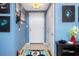 Interior entryway with blue walls and Mickey Mouse rug at 453 Water St, Kissimmee, FL 34747