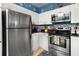Kitchen boasts stainless steel appliances and a Mickey Mouse-themed backsplash at 453 Water St, Kissimmee, FL 34747