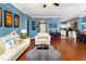 Open living space with hardwood floors, comfy seating, and kitchen view at 453 Water St, Kissimmee, FL 34747