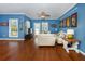 Living room with hardwood floors, white couch and blue walls at 453 Water St, Kissimmee, FL 34747