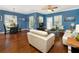 Bright living room with hardwood floors, comfy seating, and Mickey Mouse decor at 453 Water St, Kissimmee, FL 34747