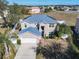 Two-story house, two-car garage, solar panels on the roof, and a landscaped yard at 513 Big Black Way, Kissimmee, FL 34759