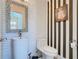 Modern powder room with a pedestal sink and stylish wall decor at 513 Big Black Way, Kissimmee, FL 34759