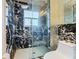 Modern bathroom with a large glass shower and marble tile at 513 Big Black Way, Kissimmee, FL 34759