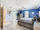 Blue and white bedroom with marble floors and a large bed at 513 Big Black Way, Kissimmee, FL 34759