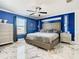 Blue and white bedroom with marble floors and a large bed at 513 Big Black Way, Kissimmee, FL 34759