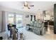 Living room features a gray sectional, views of the kitchen and backyard at 513 Big Black Way, Kissimmee, FL 34759