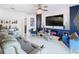 Spacious living room with a large TV, fireplace, and comfortable seating at 513 Big Black Way, Kissimmee, FL 34759