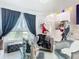 Living room with chic decor, featuring a large window and plush seating at 513 Big Black Way, Kissimmee, FL 34759