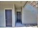 Exterior view of a building entrance with two doors and a staircase at 5980 Westgate Dr # Apt 103, Orlando, FL 32835