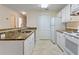 Efficient kitchen with white cabinets, granite countertops, and modern appliances at 5980 Westgate Dr # Apt 103, Orlando, FL 32835