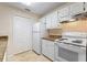 Kitchen with granite countertops and white cabinets at 5980 Westgate Dr # Apt 103, Orlando, FL 32835