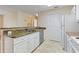 Kitchen with granite countertops and white cabinets at 5980 Westgate Dr # Apt 103, Orlando, FL 32835