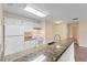 Kitchen with granite countertops and white cabinets at 5980 Westgate Dr # Apt 103, Orlando, FL 32835