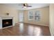 Living room featuring a fireplace, wood flooring and ceiling fan at 5980 Westgate Dr # Apt 103, Orlando, FL 32835