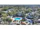 Aerial view of community pool, gazebo, and tennis court at 5980 Westgate Dr # Apt 103, Orlando, FL 32835