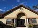 Community clubhouse with columns and a circular emblem at 8121 Roseville Blvd, Davenport, FL 33896