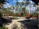 Community pool with orange lounge chairs and umbrellas at 8121 Roseville Blvd, Davenport, FL 33896